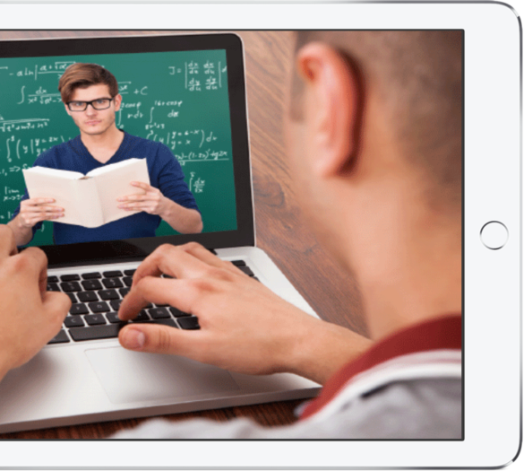 Young man at laptop watching a math video