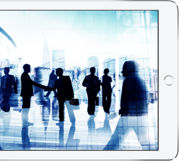 Silhouette of business professionals shaking hands and walking in front of city skyline